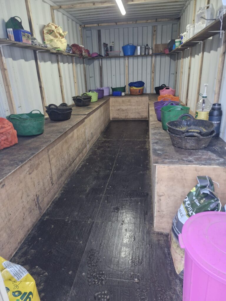 A shipping container storing feed and trugs